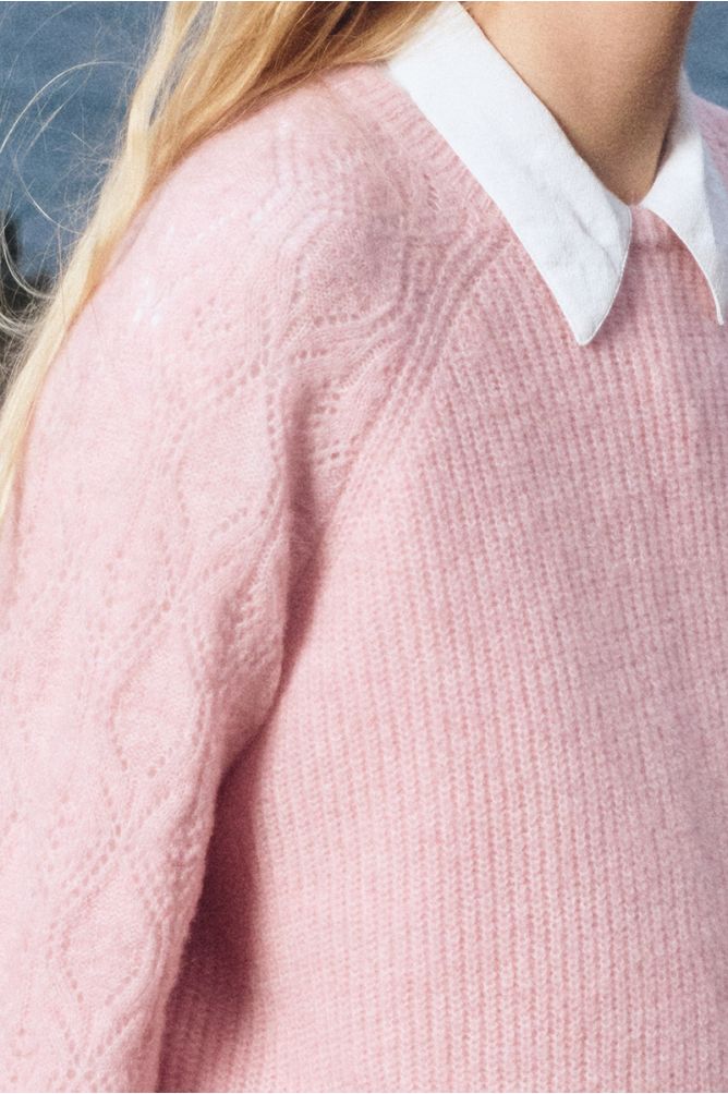 Knitted sweater with openwork sleeves